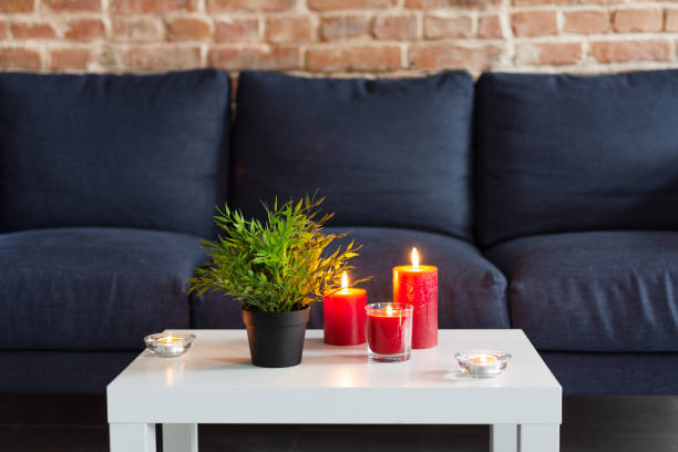 istock Room air refresher sticks and red burning candles on table on home modern interior. 1184342439