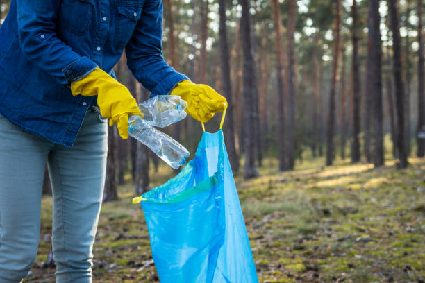 istock Save the planet! Volunteer cleaning plastic garbage in nature. 1184342450