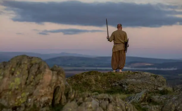 An individual viking warrior man on highland moors