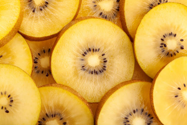 golden kiwi sliced golden kiwi macro closeup kiwi fruit stock pictures, royalty-free photos & images