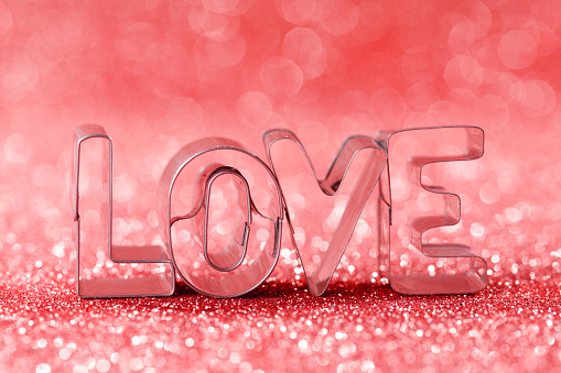 Word love on red bright glitter lights bokeh background