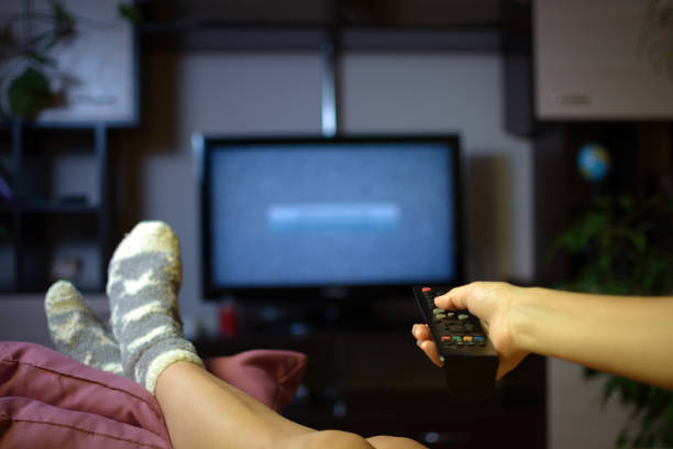 istock Hand holds remote and turns on the TV 1184346858
