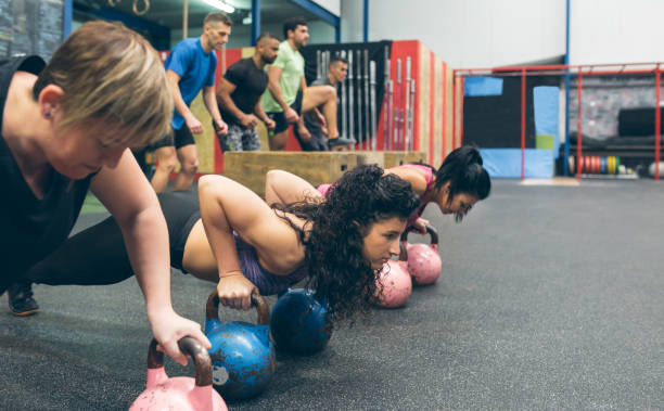istock Sportswomen doing push-ups with kettlebells 1184347981