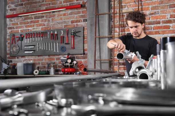 istock man work in home workshop garage with caliper measure metal pipe on the workbench full of wrenches, diy and craft concept 1184347995