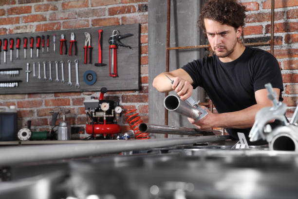 istock man work in home workshop garage with caliper measure metal pipe on the workbench full of wrenches, diy and craft concept 1184347997
