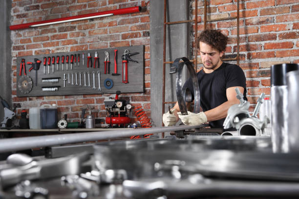 istock man work in home workshop garage with bench grip vise fix a metal on the workbench full of wrenches, diy and craft concept 1184347998