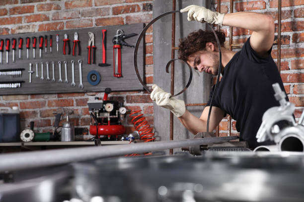 istock man work in home workshop garage with bench grip vise fix a metal on the workbench full of wrenches, diy and craft concept 1184347999