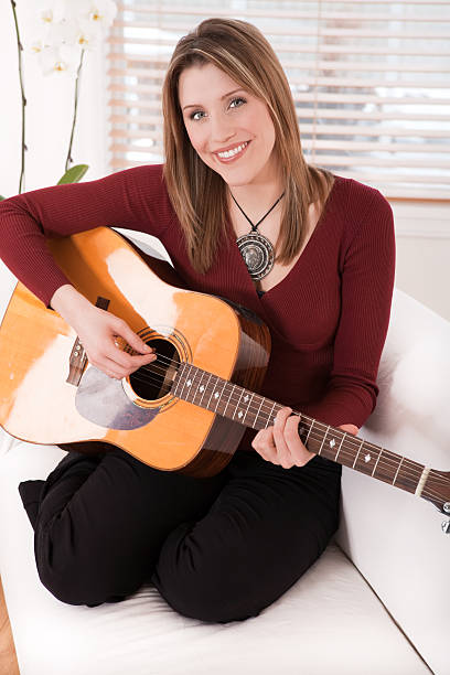 istock Smiling woman playing the guitar 118434802
