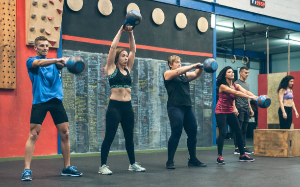 istock Athletes exercising with kettlebells indoors 1184348563