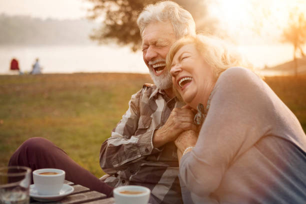 Happy senior couple smiling from the heart stock photo