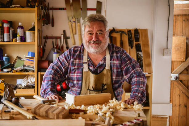 istock Portrait of cheerful mature joiner in workshop 1184350166