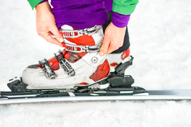 Legs of a professional skier at the time of relaxation on the ski slope. A winter sports concept with an adventurous guy on top of the mountain who is ready to ride down.