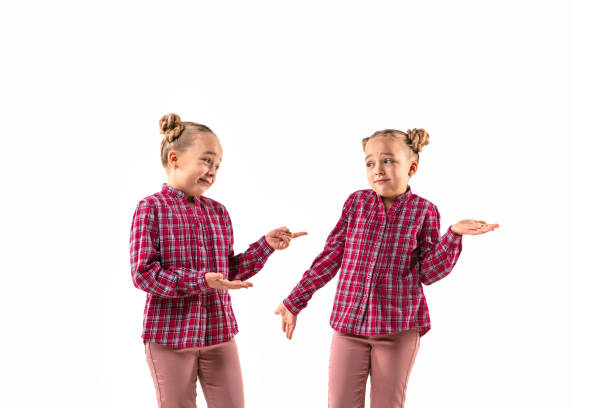 istock Young handsome girl arguing with herself on white studio background. 1184353635