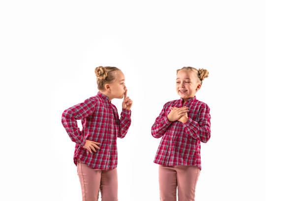 istock Young handsome girl arguing with herself on white studio background. 1184353636