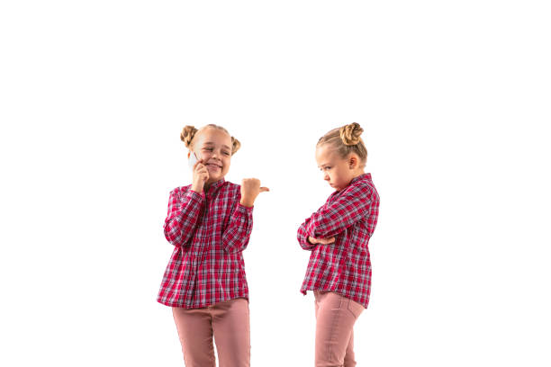 istock Young handsome girl arguing with herself on white studio background. 1184353679