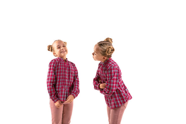 istock Young handsome girl arguing with herself on white studio background. 1184353682
