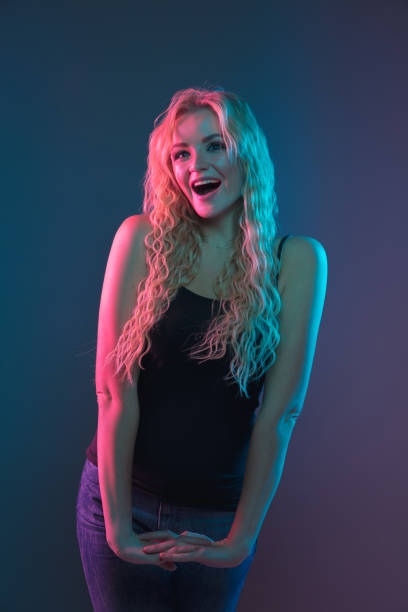 istock Caucasian young woman's portrait on gradient background in neon light 1184354399