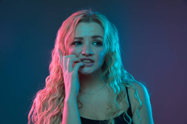 istock Caucasian young woman's portrait on gradient background in neon light 1184354409
