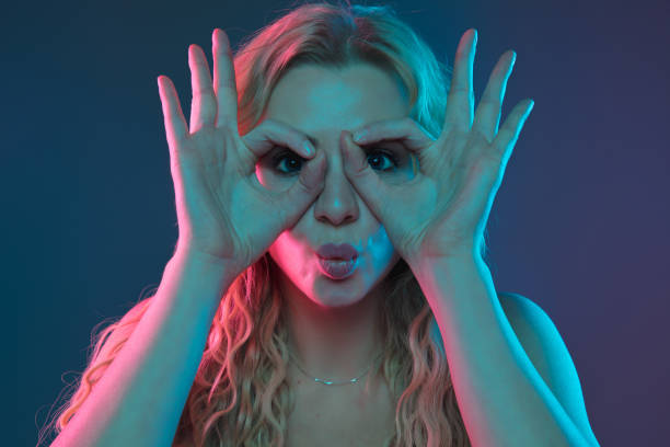 istock Caucasian young woman's portrait on gradient background in neon light 1184354418