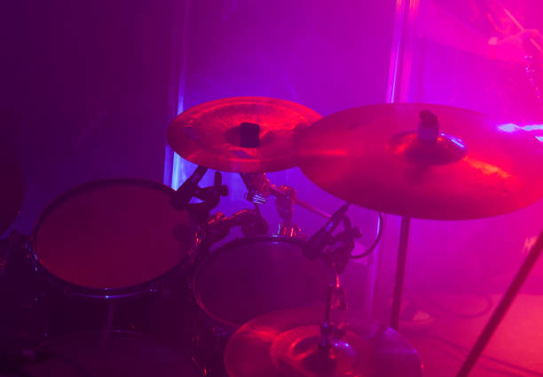 istock Rock band drum set in purple lights 1184355679