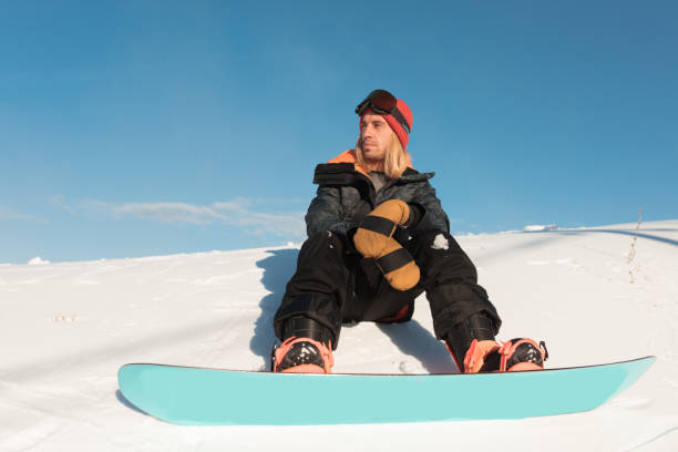 istock serious pensive man sitting on the snow 1184359796