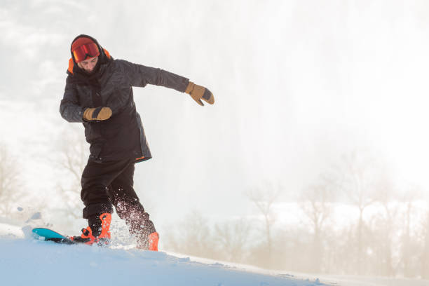 istock the begginer snowboarder . copy space 1184359939