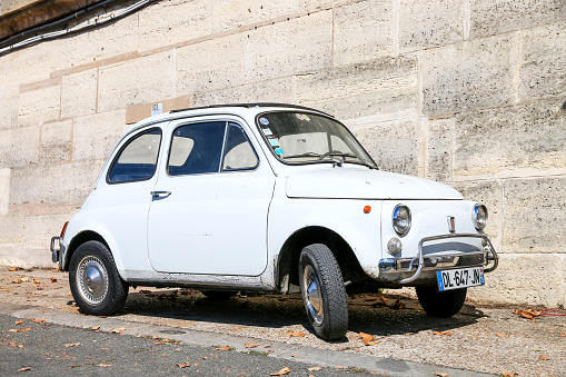 Paris, France - September 15, 2019: White retro car Fiat 500 in the city street.