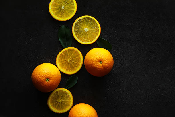 istock Orange citrus fruit on a stone table. Orange background. 1184361437