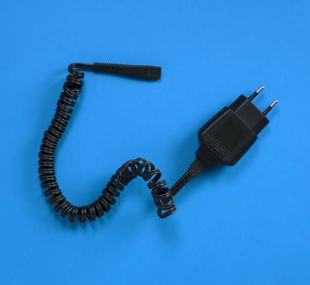 istock Black charger (220v) isolated on a blue background 1184365036