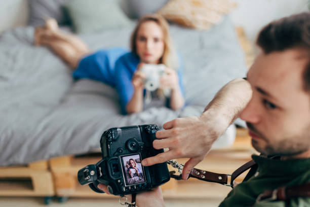 istock creative photographer pointing at the screen of the camera 1184365546