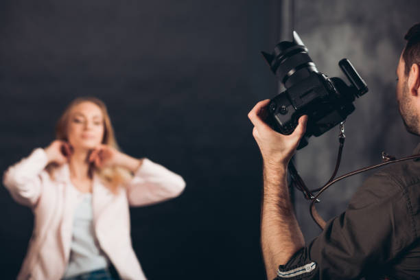 istock attractive fair-haired girl doing hairstyle before the photo session 1184367021