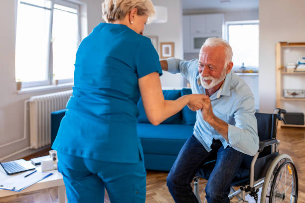 istock Carer helping an elderly man in a wheelchair 1184367245