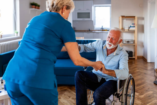 istock Carer helping an elderly man in a wheelchair 1184368312