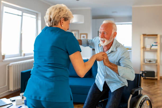 istock Carer helping an elderly man in a wheelchair 1184368450