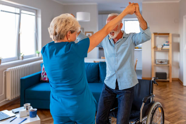 istock Carer helping an elderly man in a wheelchair 1184369291