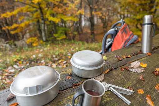 Camping gear on rotten wooden table in autumn forest, Slovenia, Europe.