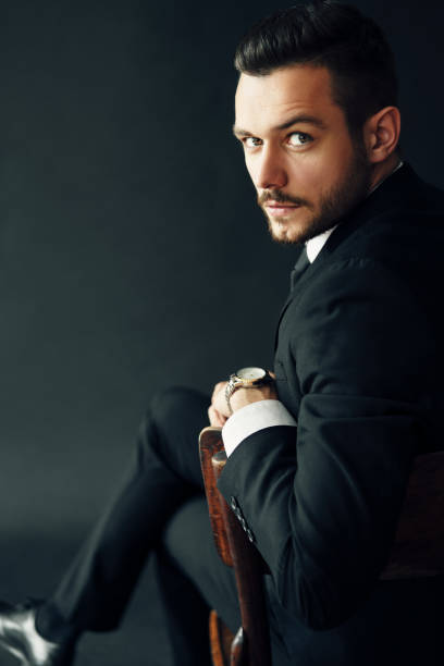 istock Handsome confident man portrait on dark background 1184370833