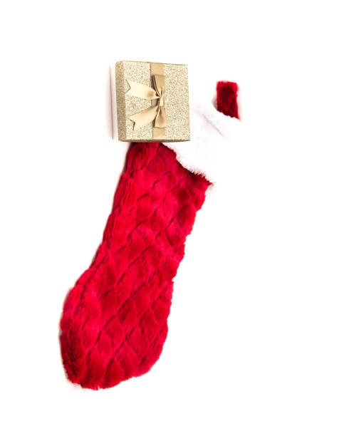 istock Studio shot yellow gift box and belt fur trimmed red sock isolated on white 1184372110