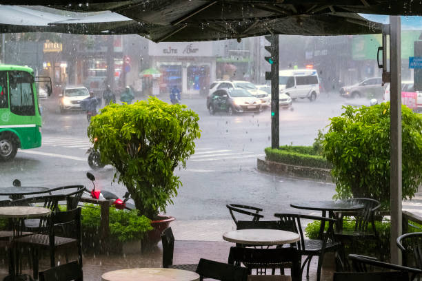 Raining Cats and Dogs at Ho Chi Minh / Saigon Traffic Jam, Vietnam Ho Chi Minh, Vietnam - August 20, 2019: Appearance from Ho Chi Minh / Saigon Traffic jam day time. Raining Cats and Dogs at Ho Chi Minh / Saigon Traffic, Vietnam with vehicles, motorcycles, buses, peoples and Fog. Traffic jam,rush hour, rain day. rainy cafe stock pictures, royalty-free photos & images