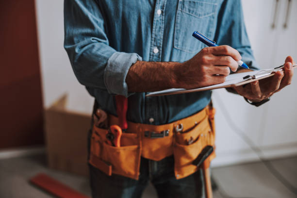 istock Construction worker writing on clipboard stock photo 1184375508