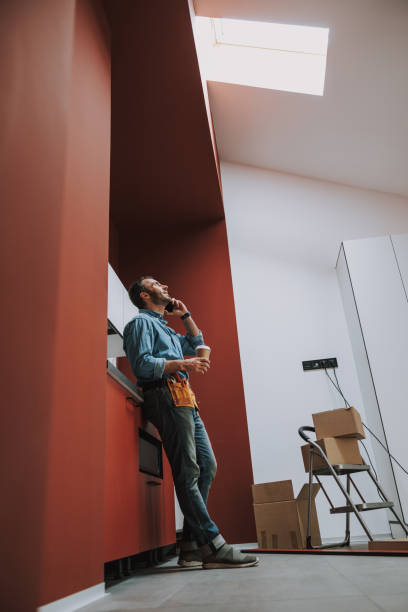 istock Talking on the phone in repaired kitchen stock photo 1184375549