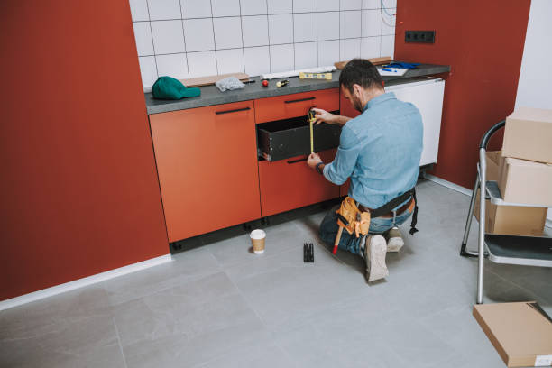 istock Repairman is fixing wood shelf at home 1184376107