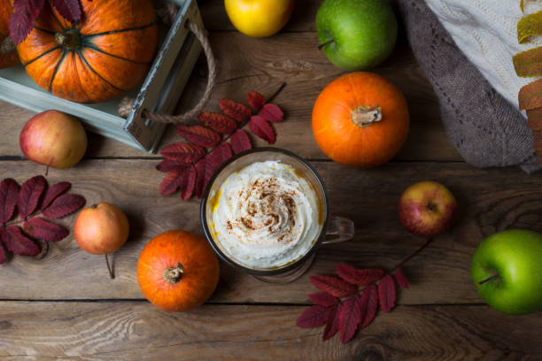 istock Pumpkin spice coffee latte with cream and cocoa, top view 1184376361