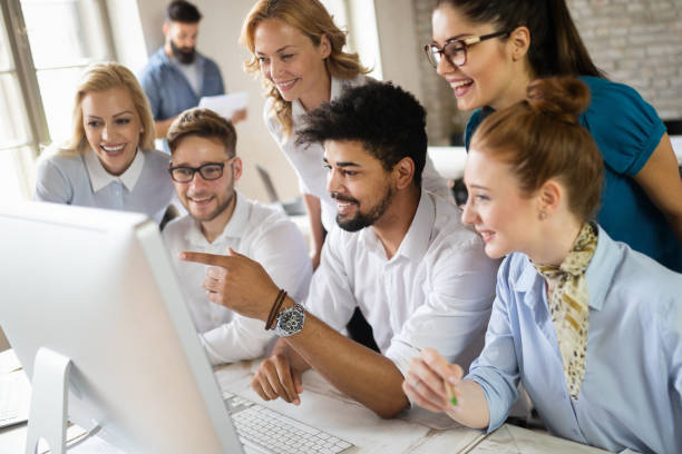 istock Successful happy group of people learning software engineering and business during presentation 1184378536