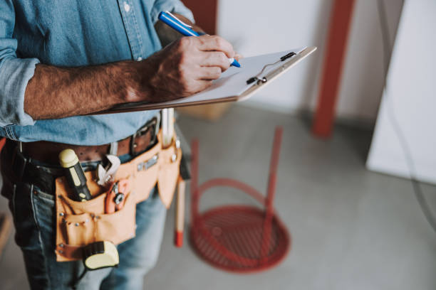 istock Close up of handyman taking notes indoors 1184378634
