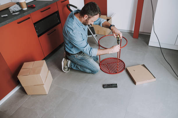 istock Young handyman is repairing a coffee table 1184378657
