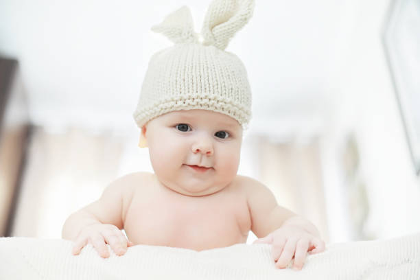istock A newborn baby is lying on a soft bed. 1184378815