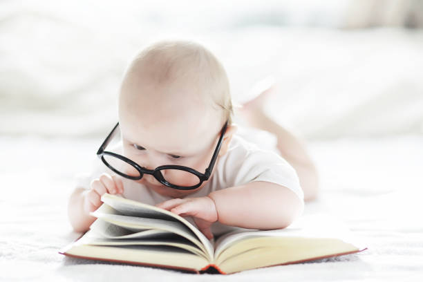 istock A newborn baby is lying on a soft bed in glasses. 1184380455