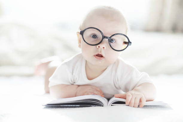 istock A newborn baby is lying on a soft bed in glasses. 1184380478