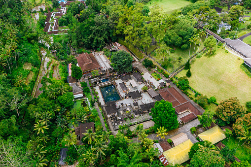 Aerial view of Tirta Empul Temple on Bali. Buddhist temple surrounded by rainforest.